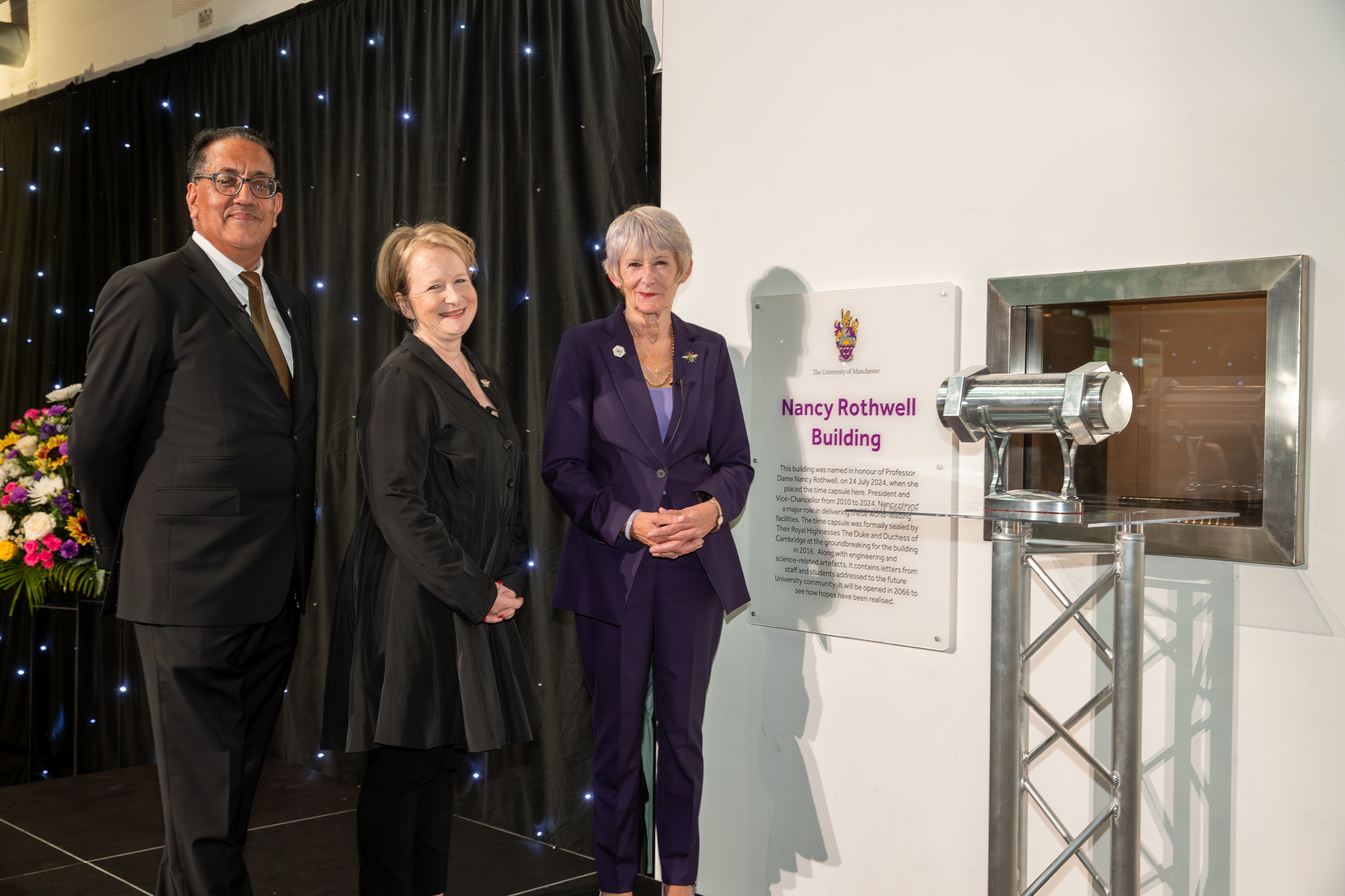 Nancy Rothwell, Philippa Hird and Nazir Afzal standing by a plaque of building