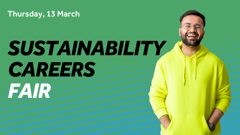 Male student standing next to sustainability careers fair copy