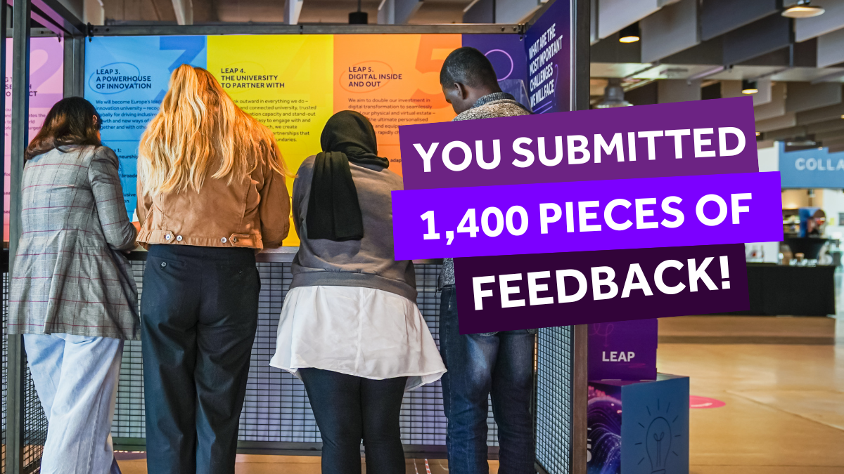 Students with their back to camera, filling out their feedback at the M2035 pop-up in Nancy Rothwell